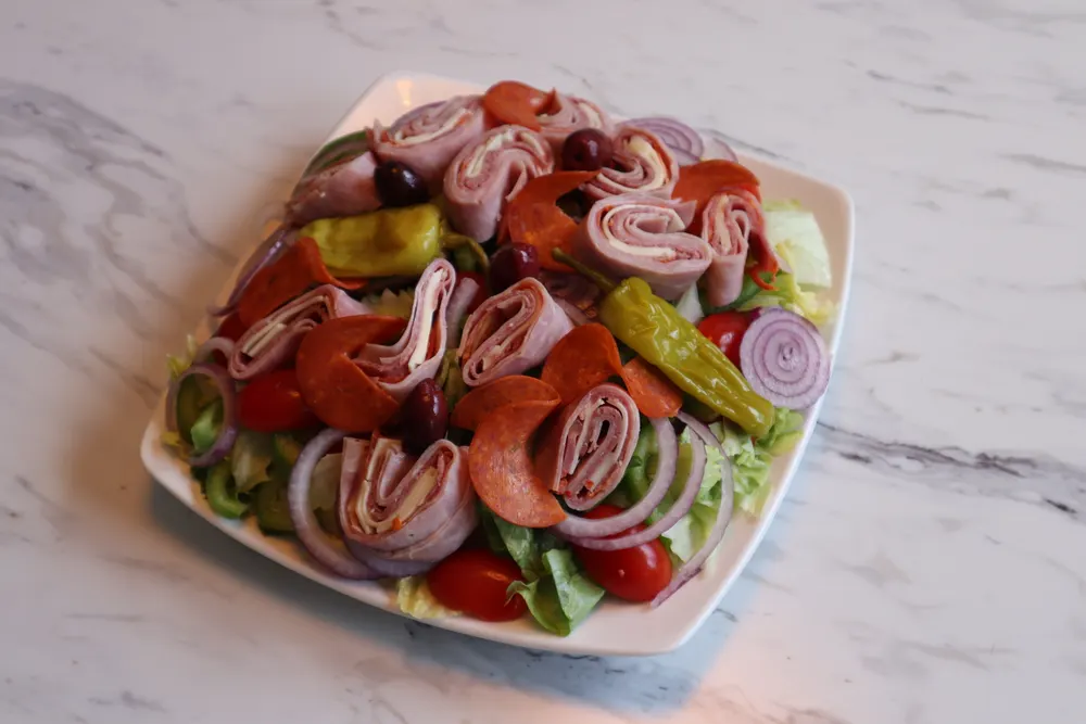 A fresh Mediterranean antipasto salad with cured meats, olives and peppers