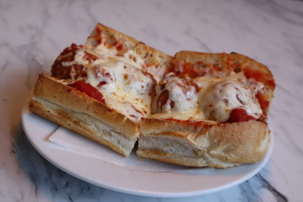 A meatball parm grinder with melted cheese