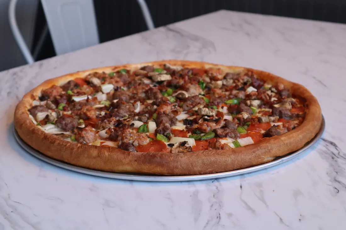 A fresh-baked pizza on a marble counter